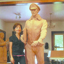 Sondra Jonson standing next to one of her sculptures